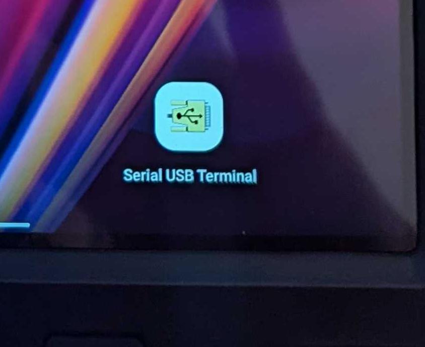 A USB-C cable connecting the diagnostic device to the Opta